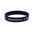 A black rubber bracelet with the inscriptions 'HONOR AND REMEMBER' and '9/11 MEMORIAL' in white and blue letters.