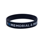 A black rubber bracelet with the inscriptions 'HONOR AND REMEMBER' and '9/11 MEMORIAL' in white and blue letters.