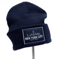 Black knit cap with tonal black patch with the NYC skyline and the words "NEW YORK CITY" and "NEVER FORGET".