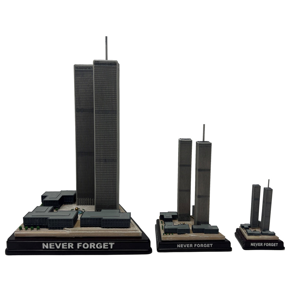 A model of the three sizes available of the Twin Towers, with the base label 'NEVER FORGET', in black, gray, and brown colors.
