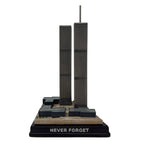 A model of the Twin Towers on a brown base with the inscription 'NEVER FORGET' on the front.