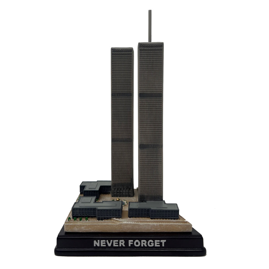 A model of the Twin Towers, with the base label 'NEVER FORGET', in black, gray, and brown colors.