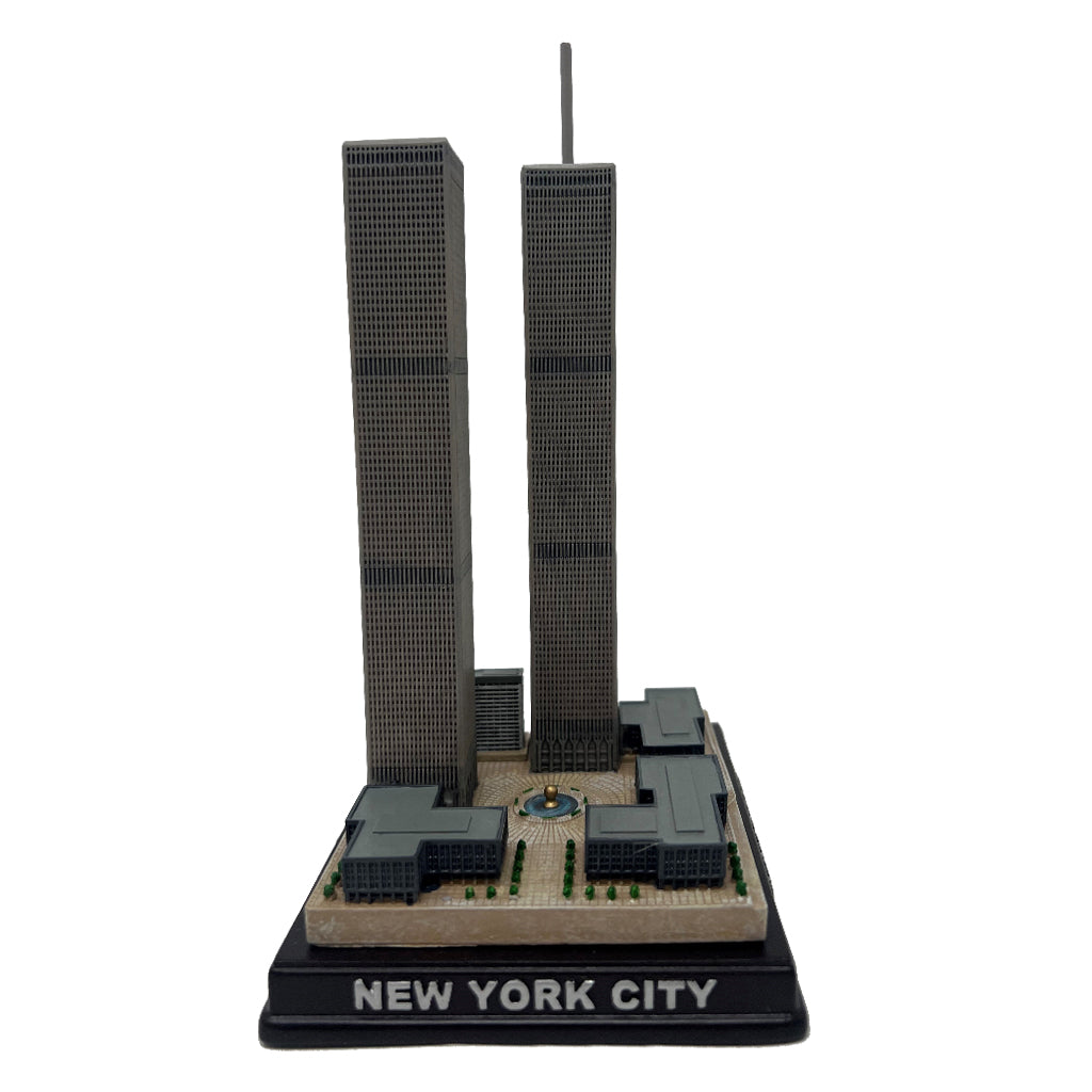 A model of the Twin Towers on a brown base with the inscription 'NEW YORK CITY' on the front.