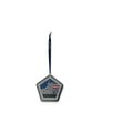 A pentagonal silver-toned commemorative ornament with a dark blue hanging ribbon, featuring a memorial design with the American flag, the Twin Towers, and the text 'NEVER FORGET".