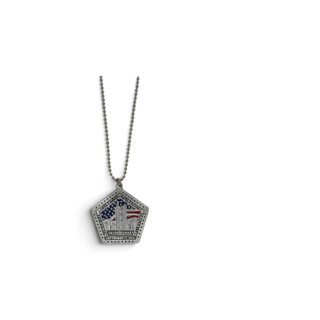 A silver pentagonal pendant necklace featuring the Twin Towers with an American flag motif, suspended from a silver ball chain against a plain white background.
