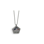 A silver pentagonal pendant necklace featuring the Twin Towers with an American flag motif, suspended from a silver ball chain against a plain white background.