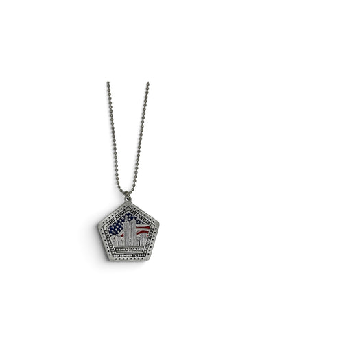 A silver pentagonal pendant necklace featuring the Twin Towers with an American flag motif, suspended from a silver ball chain against a plain white background.