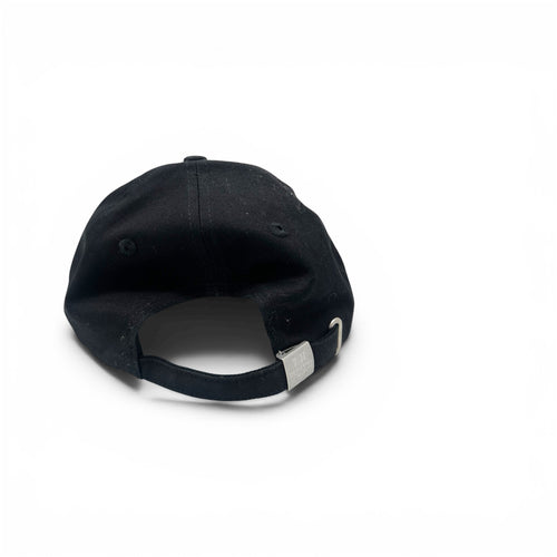 A black baseball cap shown from the back, featuring a black fabric crown, matching black eyelets, and an adjustable black strap with a silver metal slider, set against a plain white background.