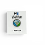 A round metal pin featuring a colorful heart design with the text 'LOVE IS STRONGER THAN HATE' in blue, green, white, and orange, on a white backer card.