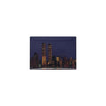 A magnet with an imprint of the skyline of New York City, prominently featuring the Twin Towers, at dusk.