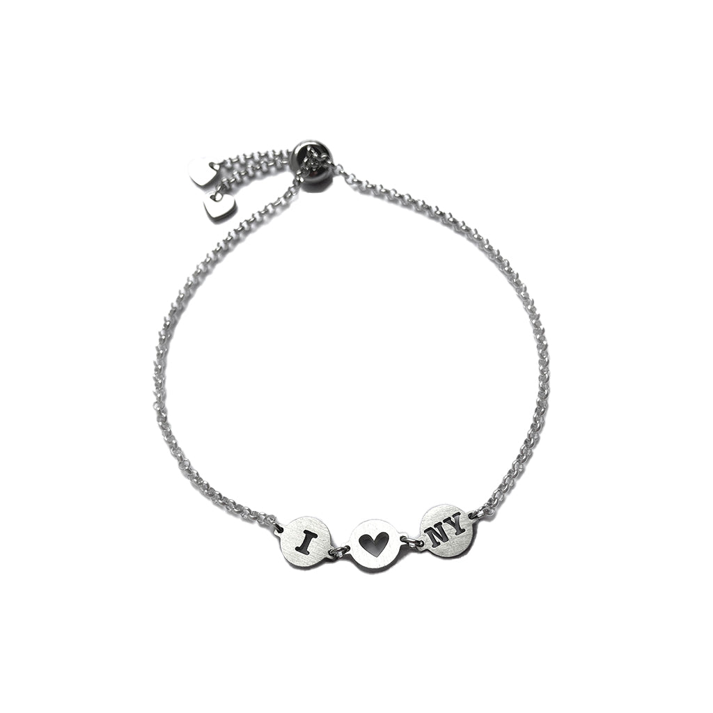 'I HEART NY' inscribed in sterling silver discs on a sterling silver adjustable rope bracelet.