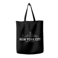 A black tote bag featuring a white printed skyline of New York City with the text 'NEW YORK CITY NEVER FORGET'.