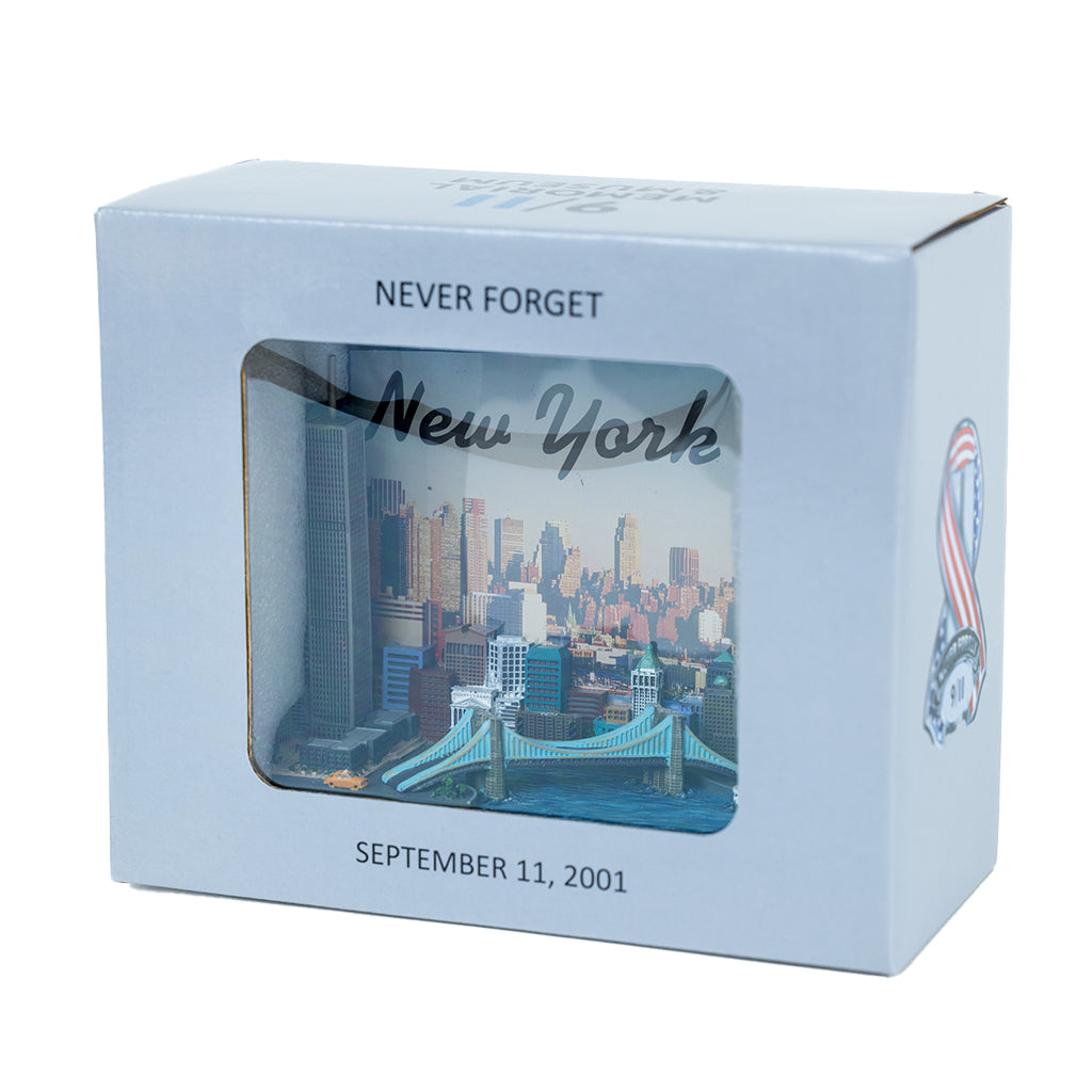 A 3D picture frame featuring the New York City skyline with the text 'NEW YORK CITY' on it. The frame includes iconic landmarks such as the Twin Towers and the Statue of Liberty in a grey box with the words 'NEVER FORGET' and 'SEPTEMBER 11, 2001'.