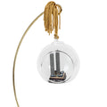 A glass keepsake ornament with a gold-colored cord, containing a miniature replica of the Twin Towers and displayed on a gold ornament holder.