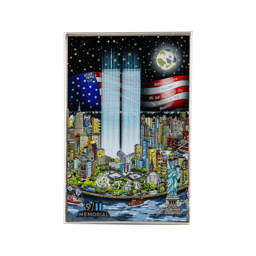 A pop art metal photo magnet featuring Lower Manhattan and the American flag with a '9/11 Memorial' label at the bottom.