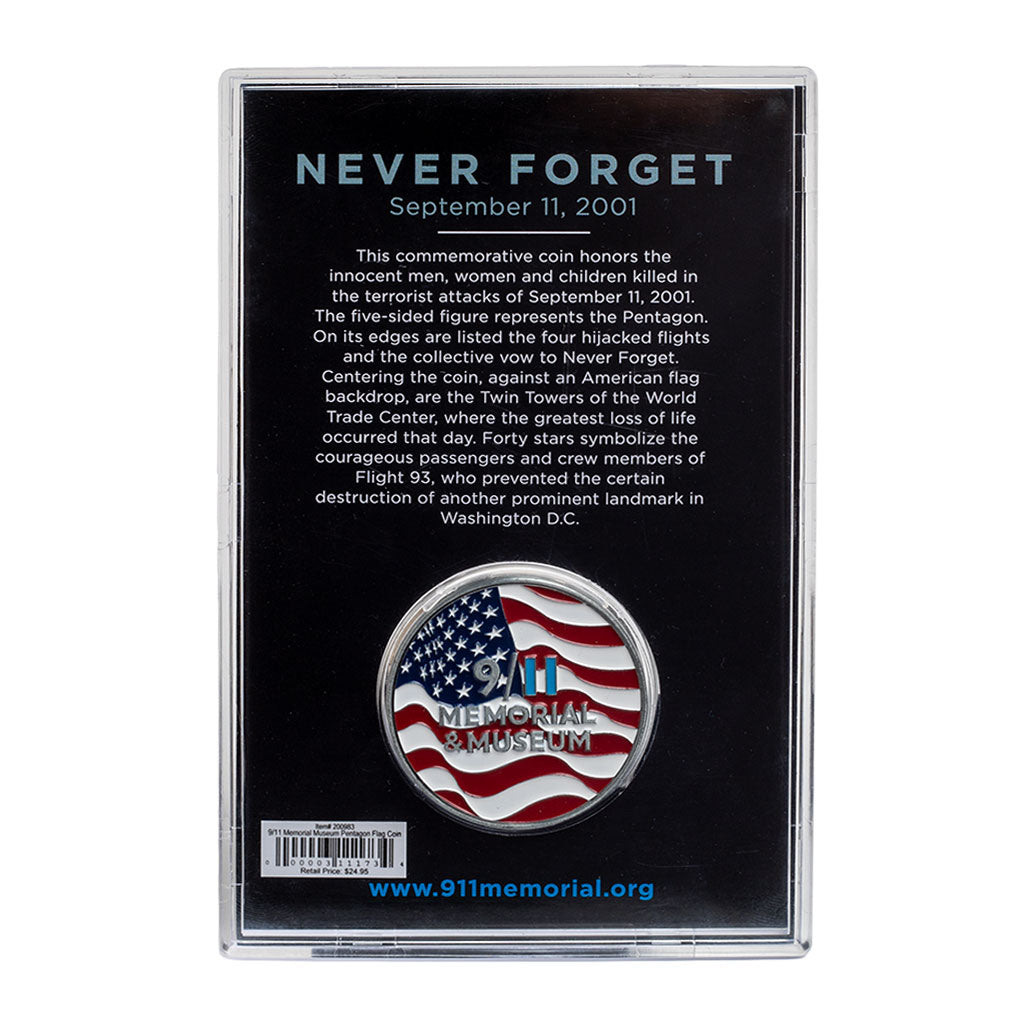 A commemorative coin with a US flag and Twin Towers design, housed in a clear display case, with 'NEVER FORGET' text on the case.