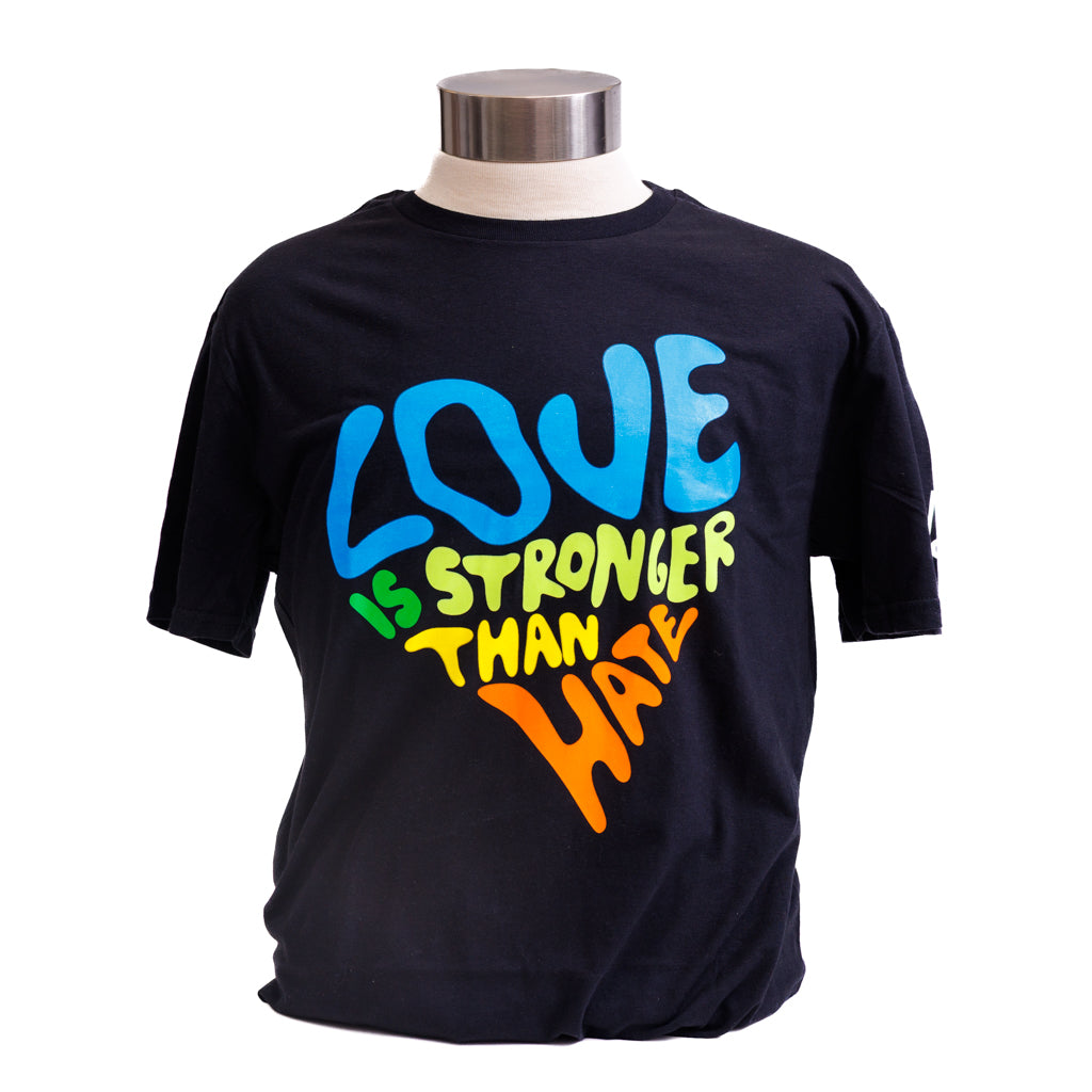 Black t-shirt with colorful text 'LOVE IS STRONGER THAN HATE' on a mannequin.