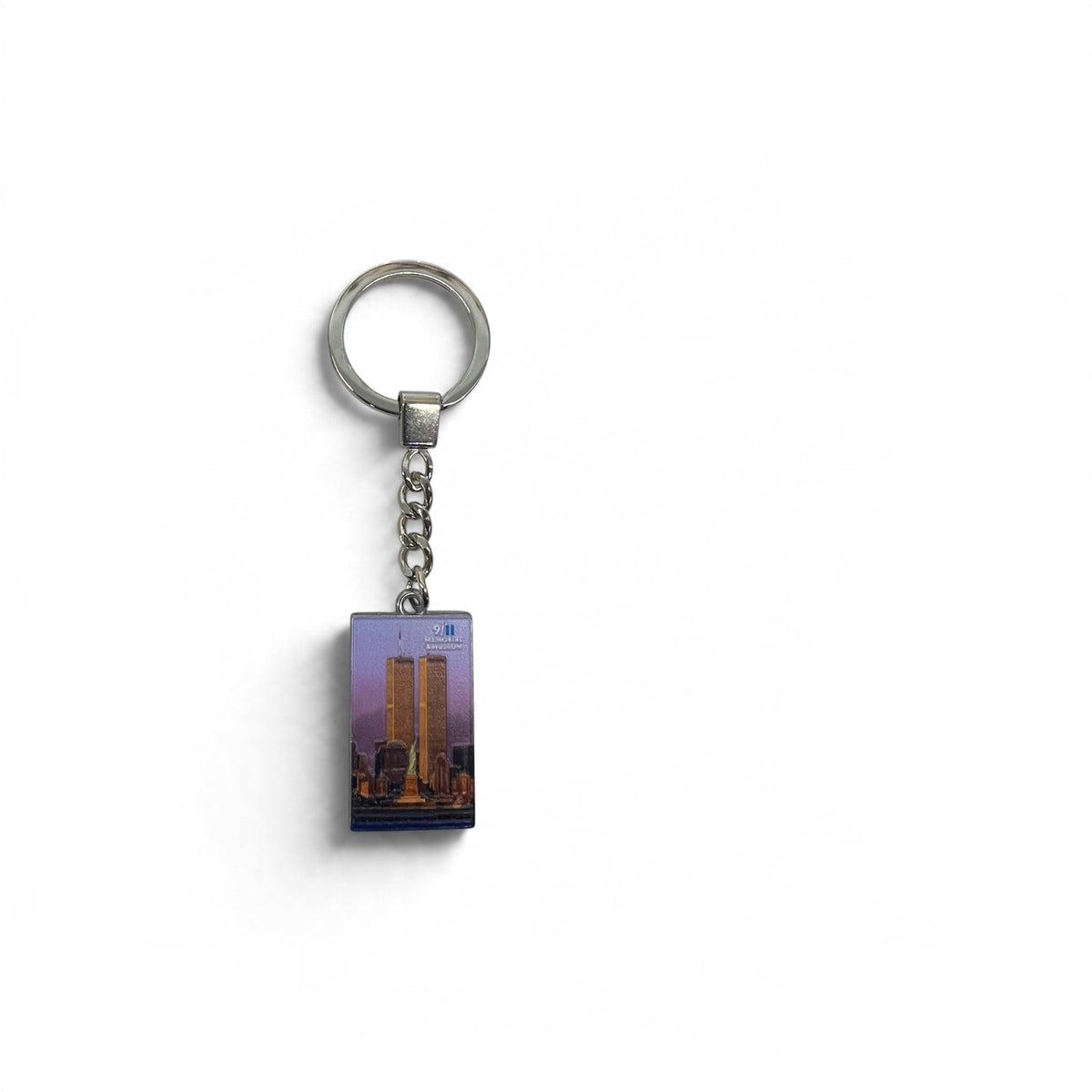 Twin Tower and Statue of Liberty image with a pink background on a silver tone keychain.