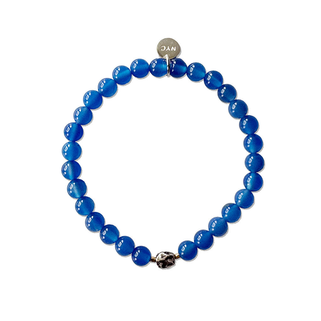 Blue beaded bracelet with a silver clasp on a white background