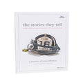 Book titled 'The Stories They Tell' with a fire helmet illustration on a white background