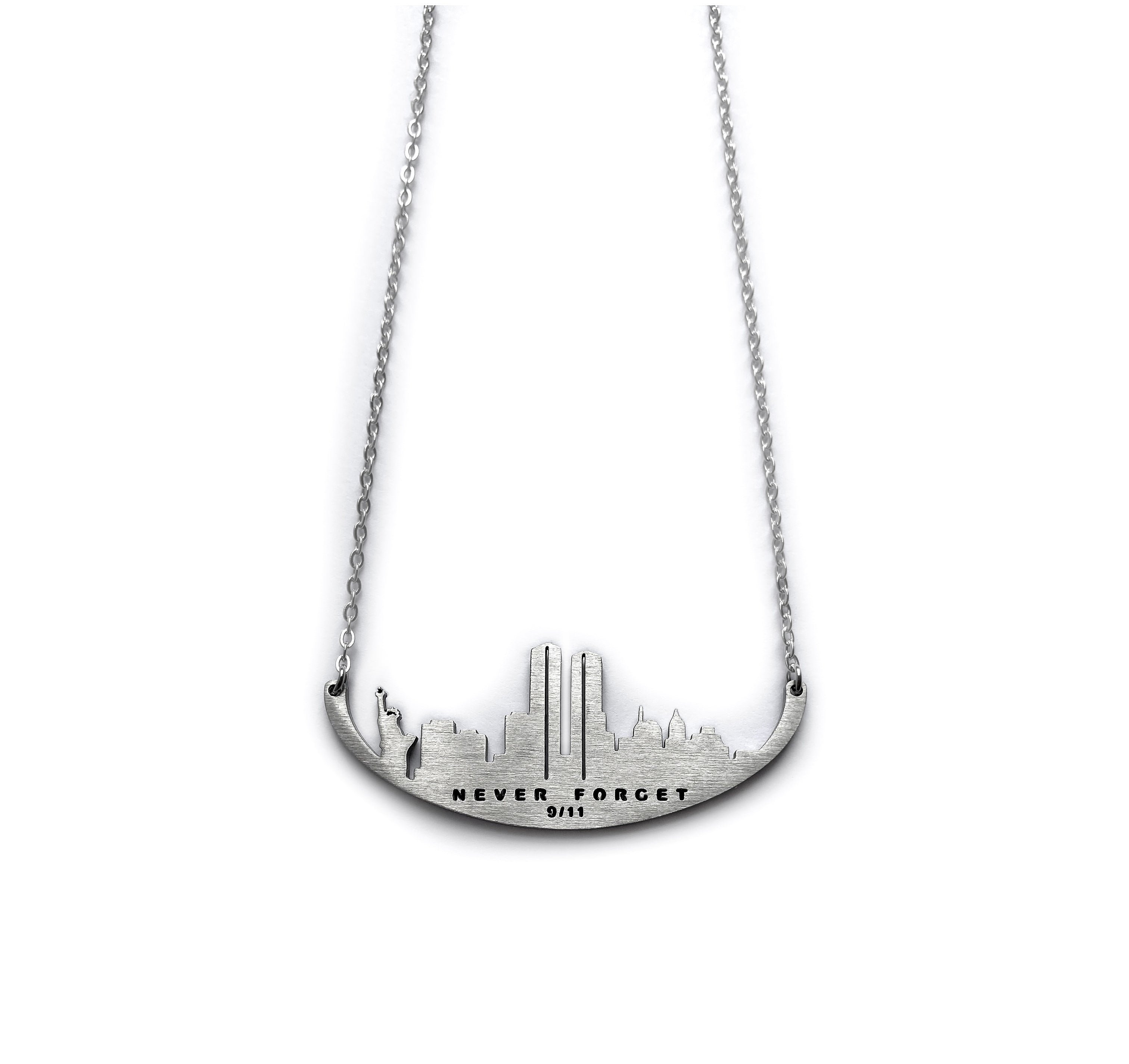 A stainless steel necklace with a skyline silhouette and the text 'NEVER FORGET 9/11' inscribed on it.
