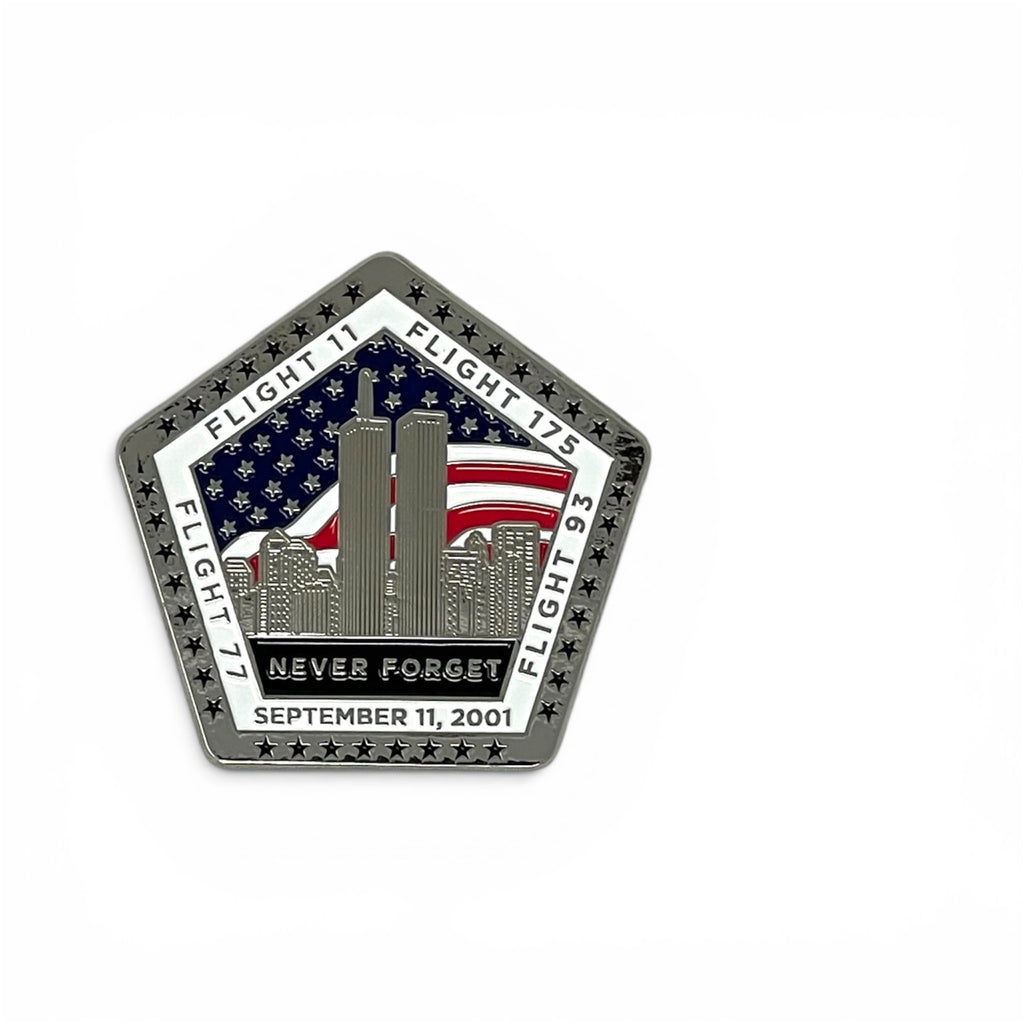 A pentagonal commemorative metal magnet featuring the Twin Towers, an American flag, and the text 'NEVER FORGET SEPTEMBER 11, 2001' on a white background.