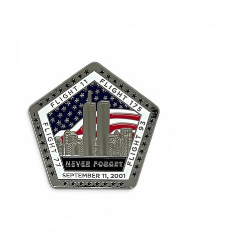 A pentagonal commemorative metal magnet featuring the Twin Towers, an American flag, and the text 'NEVER FORGET SEPTEMBER 11, 2001' on a white background.