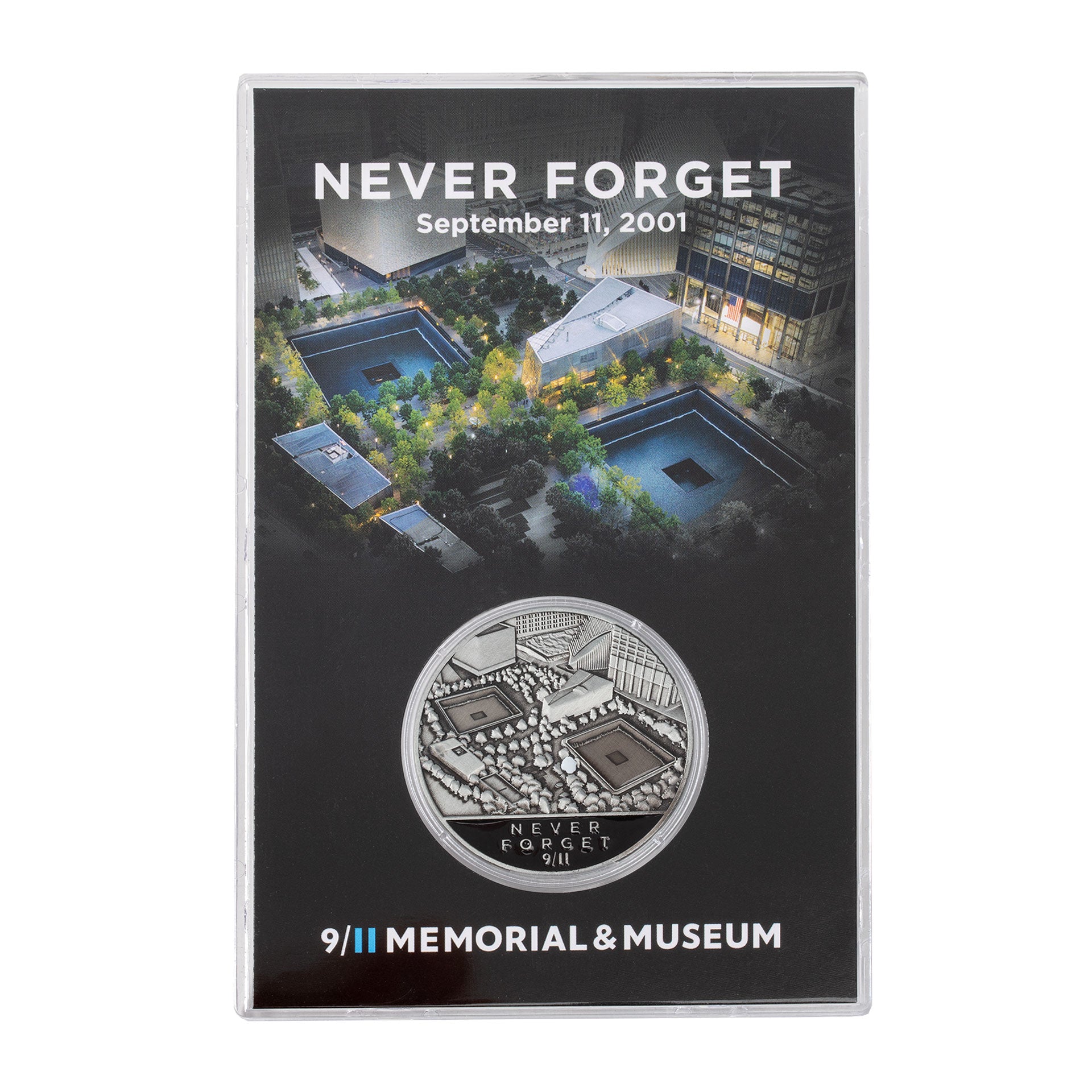 A collectible coin in a case, with the inscription 'NEVER FORGET September 11, 2001' and the logo of the 9/11 Memorial & Museum.