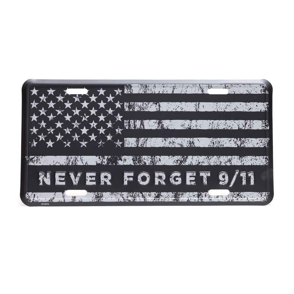 A license plate with a black and grey American flag design and the text 'NEVER FORGET 9/11' on it.
