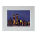 A print with an imprint of the skyline of New York City, prominently featuring the Twin Towers, at dusk.