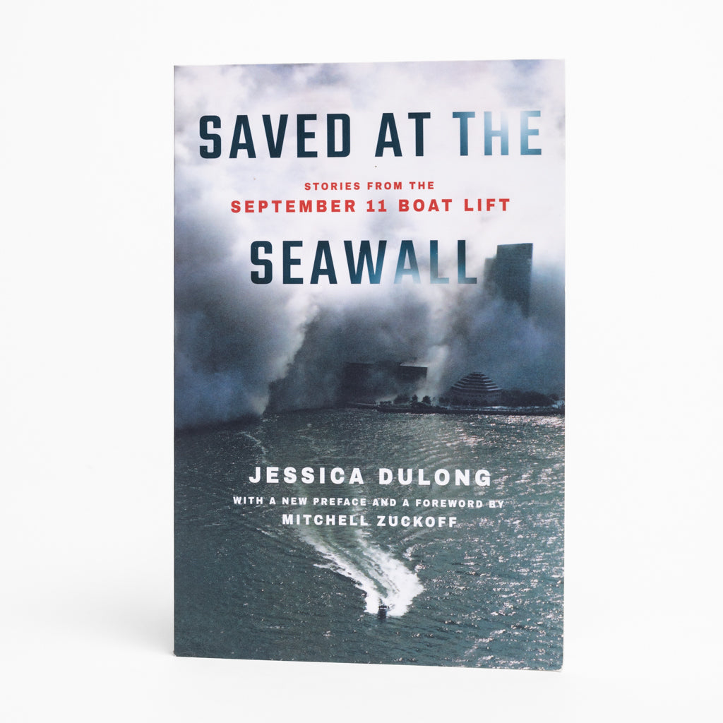 Cover of the book 'Saved at the Seawall: Stories from the September 11 Boat Lift' by Jessica DuLong, featuring a dark and dramatic sea wall background with a figure resembling a mariner or rescuer in the foreground.