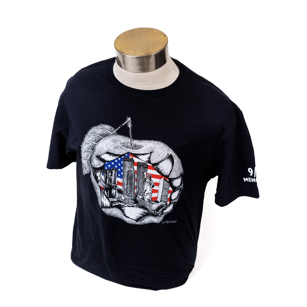 Black t-shirt with a graphic design of the an apple with the American flag and New York City landmarks, displayed on a mannequin.