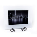 Black and white cityscape print with white matte frame.