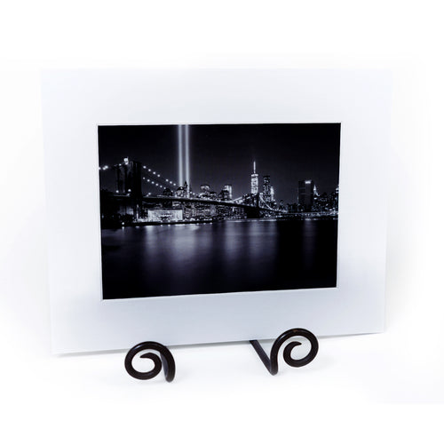 Black and white cityscape print with white matte frame.
