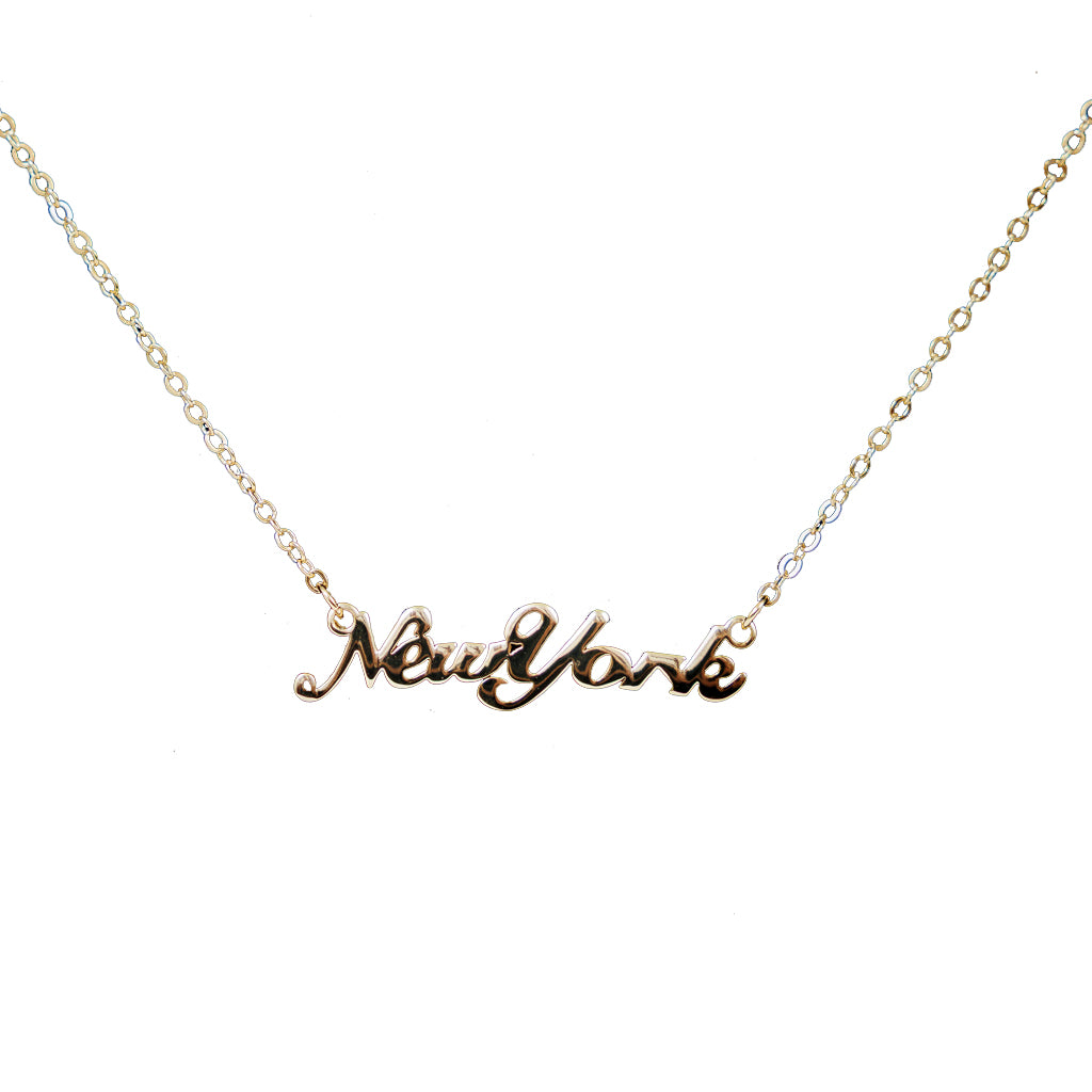 Gold 'New York' necklace on a white background