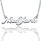 Close up of silver 'New York' necklace on a white background