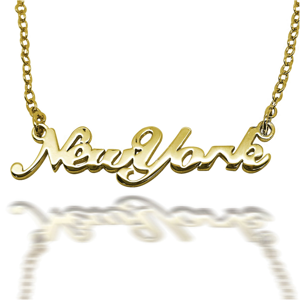 Close up of gold 'New York' necklace on a white background