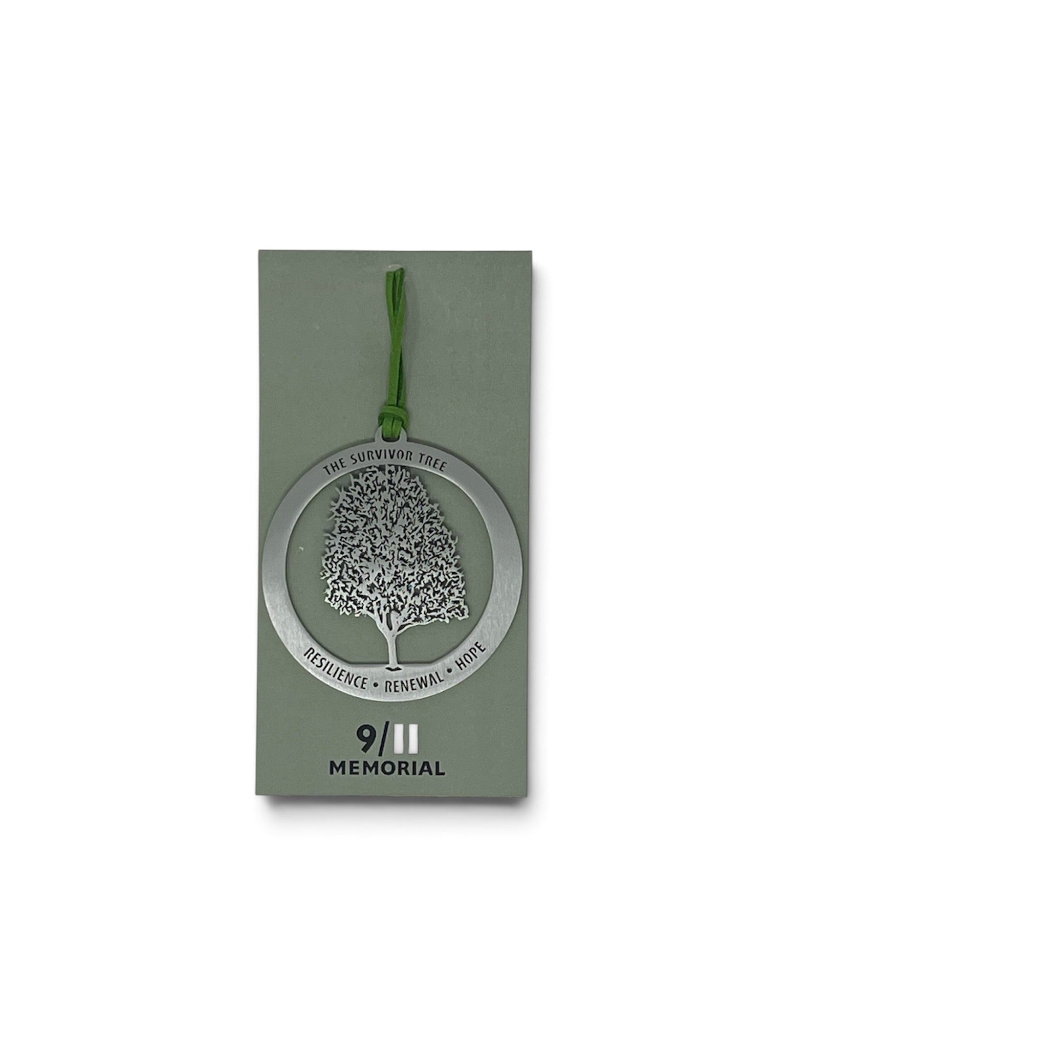 A silver metal memorial tree ornament with a green hanging string, displayed on its olive green card packaging against a white background.