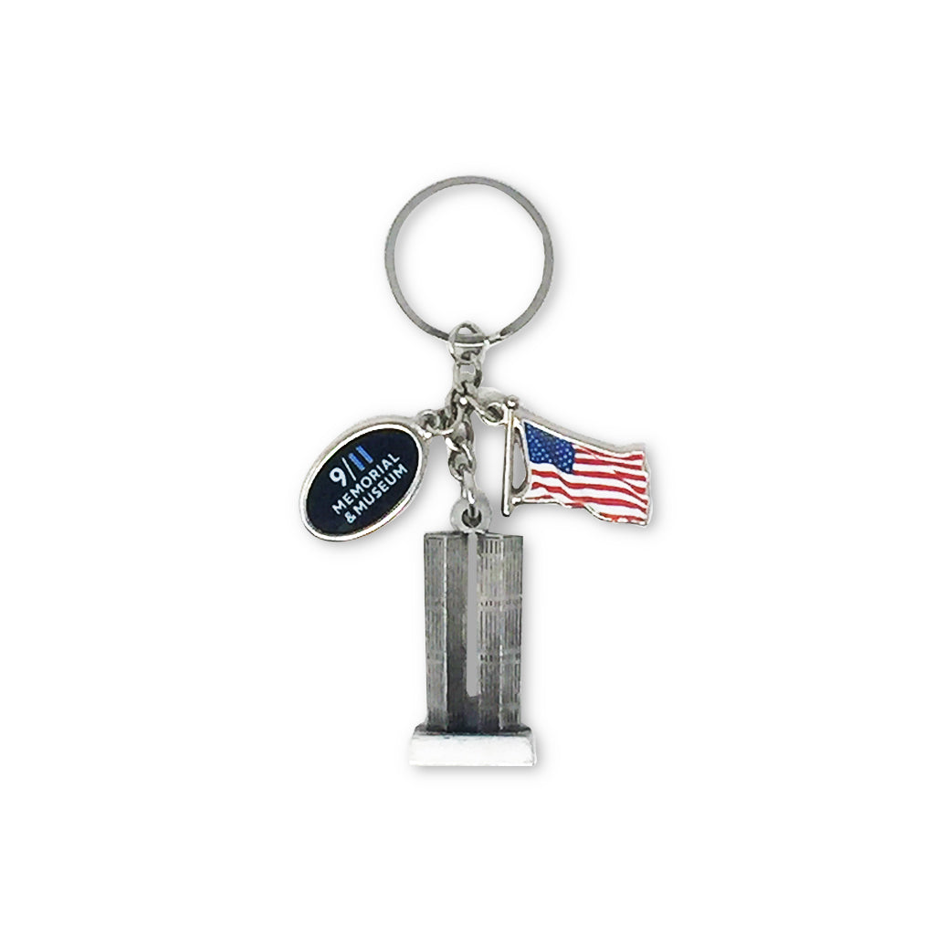 A keychain featuring a representation of the Twin Towers with a American flag and a 9/11 Memorial & Museum charm
