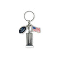 A keychain featuring a representation of the Twin Towers with a American flag and a 9/11 Memorial & Museum charm