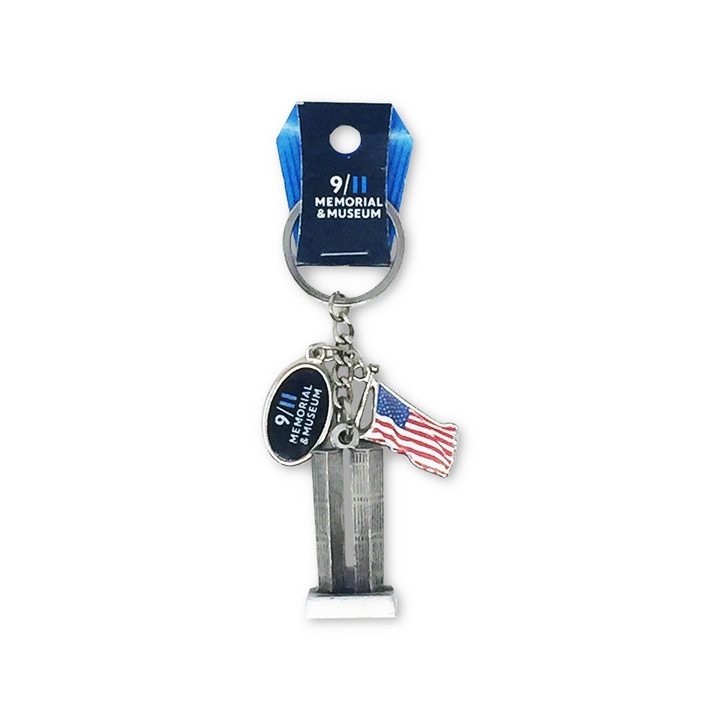 A keychain featuring a representation of the Twin Towers with a American flag and a 9/11 Memorial & Museum charm