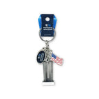 A keychain featuring a representation of the Twin Towers with a American flag and a 9/11 Memorial & Museum charm