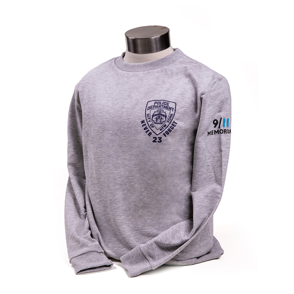 A grey NYPD crewneck sweatshirt displayed on a mannequin. It features the NYPD shield emblem on the chest and 9/11 Memorial logo on its sleeve.