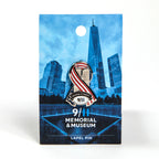 A metal die-cut ribbon lapel pin with a patriotic design featuring an American flag and the text 'Never Forget 9/11' on a blue card backer.