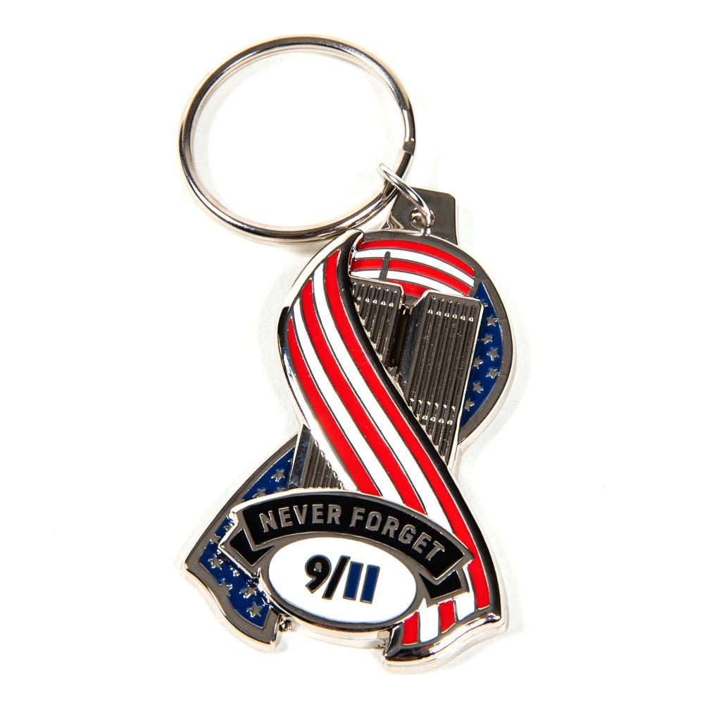 A metal die-cut ribbon keychain with a patriotic design featuring an American flag and the text 'Never Forget 9/11'.