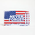 A rectangular magnet with an American flag design and the text 'Never Forget' along with the date 'September 11, 2001'.