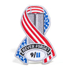 A die-cut ribbon patch with a patriotic design featuring an American flag and the text 'Never Forget 9/11'.
