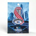 A die-cut ribbon patch with a patriotic design featuring an American flag and the text 'Never Forget 9/11' on a blue card backer.