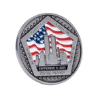 A commemorative coin with a US flag and Twin Towers design.