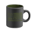 A glossy charcoal mini mug with green interior and a green American flag design and the text 'NEVER FORGET 9/11/2001' on it.